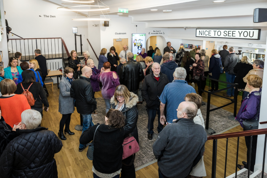 Theatre visitors in the foyer getting ready to see a show